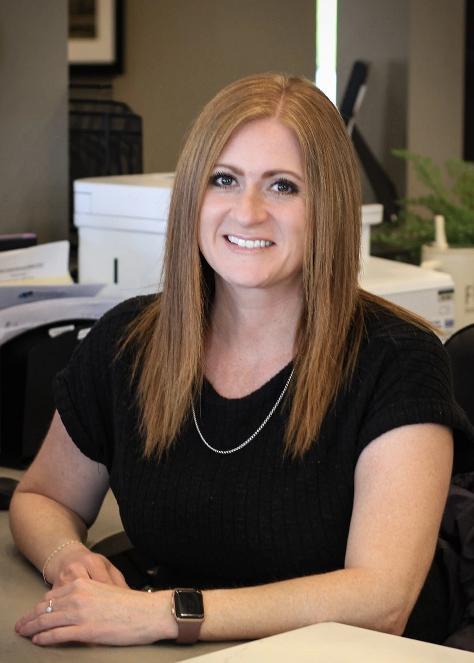 Headshot of Ashley, sitting at the front desk of Kennewick Dental.
